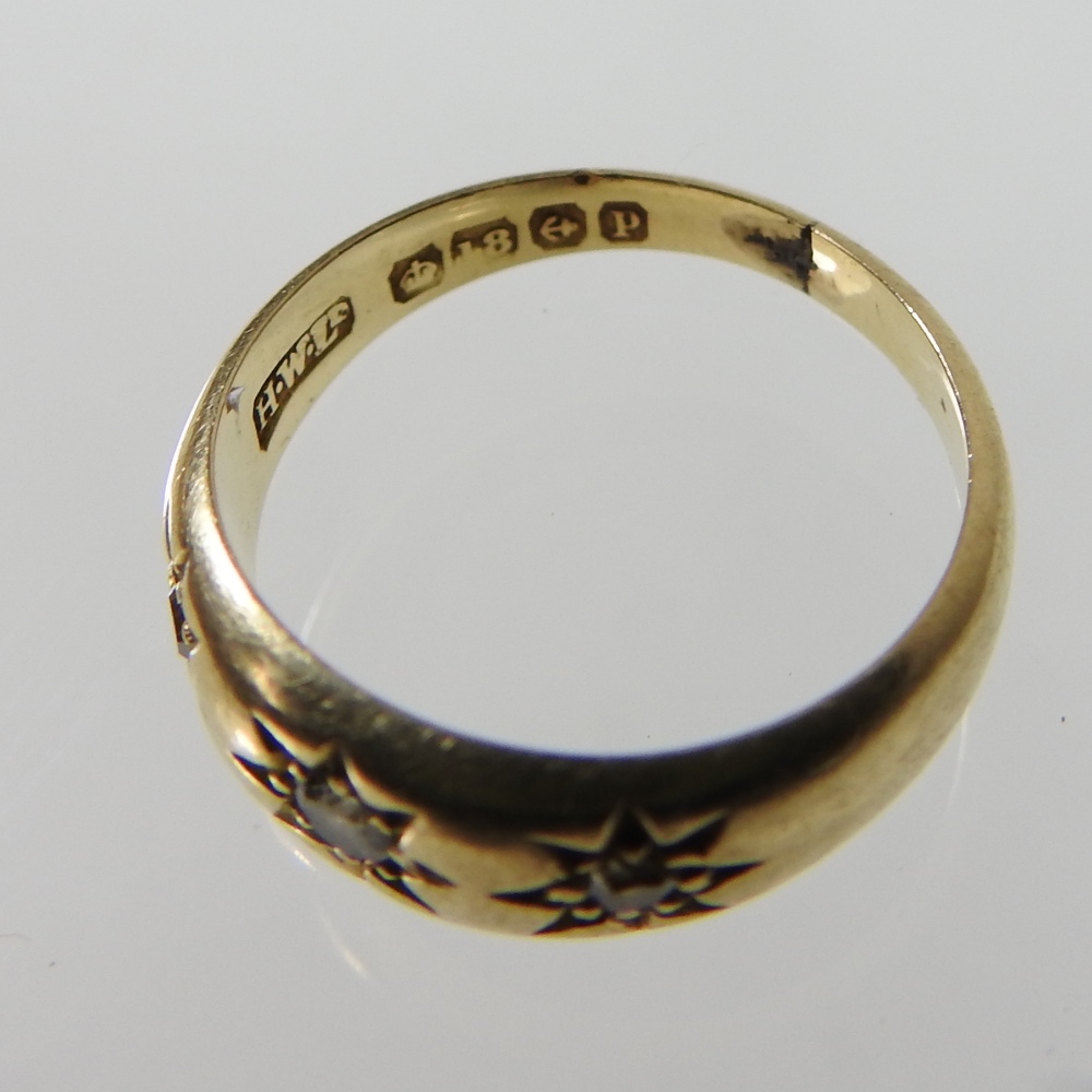 An 18 carat gold three stone diamond ring, size M, - Image 3 of 3