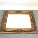 An ornate gilt framed wall mirror,