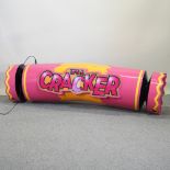 A large pink advertising sign in the form of a cracker,