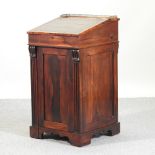 A Regency rosewood davenport, with a sliding top, fitted with short drawers,