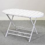 A white painted pierced metal garden table,