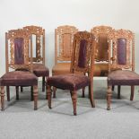 A matched set of six early 20th century carved oak and red upholstered dining chairs
