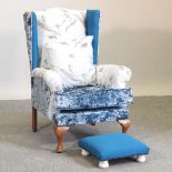 A George III style blue upholstered wing armchair,