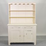 A mid 20th century cream painted dresser, with linen fold decoration,