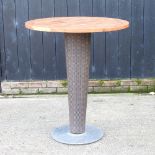 An outdoor high table, with a teak top,