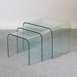 A nest of three Italian curved glass tables,