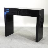 A modern black mirrored side table, by Next,