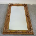 A large ornate gilt framed wall mirror,