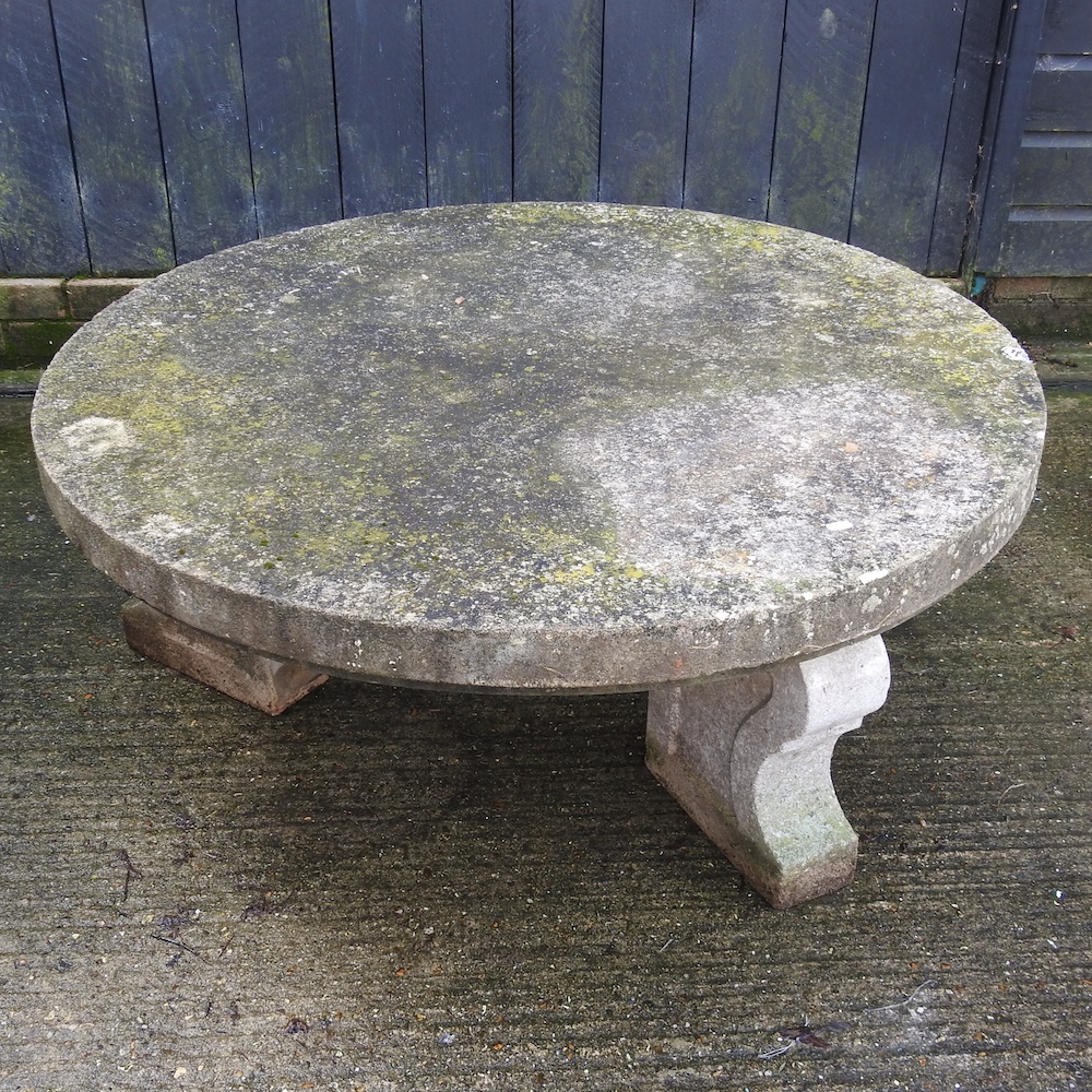 A large reconstituted stone garden circular table, 117cm diameter,