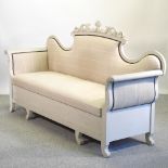 A grey painted settle, with an upholstered seat,