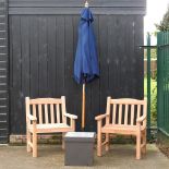 A pair of teak garden armchairs, together with a garden occasional table, 44cm,