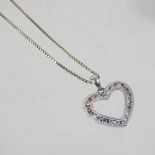 A 14 carat gold and diamond heart shaped pendant, 2cm wide, on a fine chain, 6.