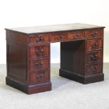 A reproduction mahogany pedestal desk, with a green inset top,