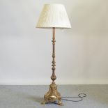 An ornate mid 20th century brass standard lamp and shade,