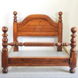 A stained pine double bedstead,