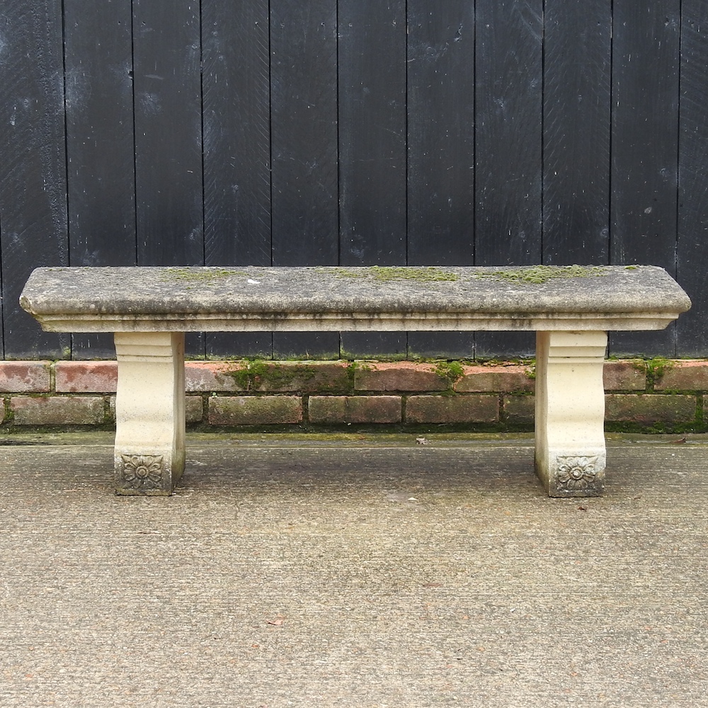 A reconstituted stone garden bench,