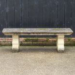 A reconstituted stone garden bench,