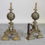 A pair of large and ornate brass andirons, each of baluster shape, with pierced decoration,