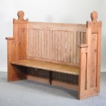 An early 20th century Gothic style pitch pine pew,