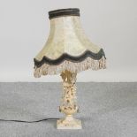 A cream painted table lamp and shade,