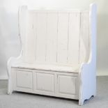 A grey painted high back settle, with a hinged seat,