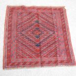 A Turkish woollen rug, with geometric design, on a red ground,