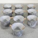 A set of ten circular galvanized metal planters,