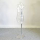 A mannequin, on a chrome stand,
