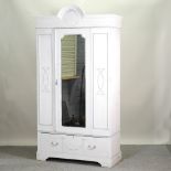 An Edwardian white painted single wardrobe, with a mirrored door,