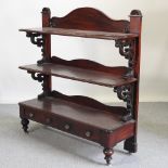 A Victorian mahogany three tier buffet, with a pair of drawers below,