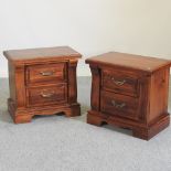 A pair of hardwood bedside cabinets,