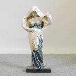 An Art Nouveau style figure of a young lady,