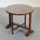 A Chinese carved hardwood occasional table, with a glass top,