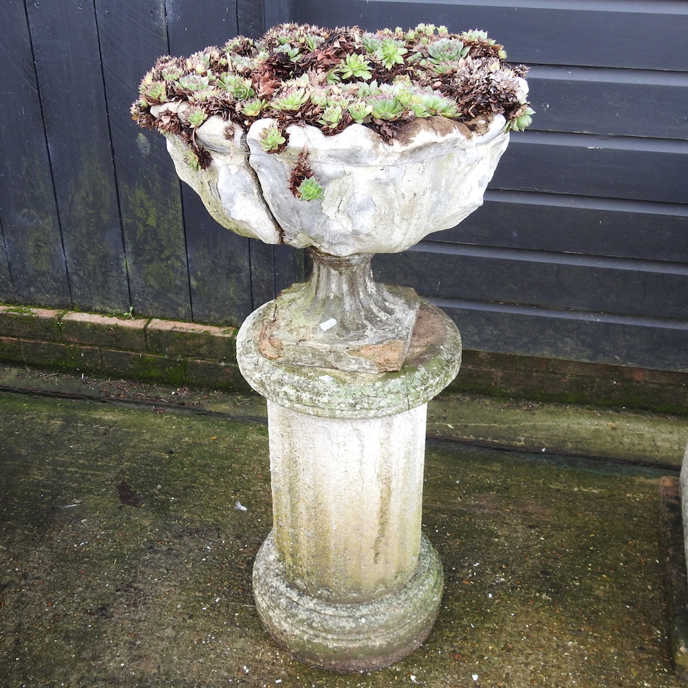 A reconstituted stone urn, on stand,