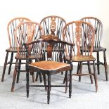 A collection of five 19th century and later elm seated wheelback dining chairs,