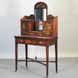An early 20th century mahogany and polychrome painted desk, having a central mirror, on square legs,