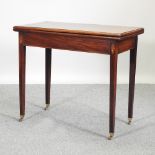 A George III mahogany and inlaid tea table, with a hinged rectangular top, on square legs,