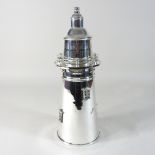 A modern plated cocktail shaker, in the form of a lighthouse,