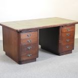 A mid 20th century pedestal desk, with an inset writing surface,