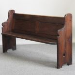 A stained pitch pine pew,