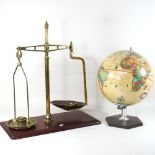 A set of mid 20th century brass scales and weights, together with a globe on stand,