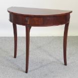 A 20th century half round side table, containing a single drawer,