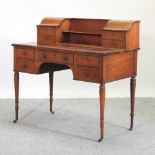 A 19th century walnut writing desk, on turned legs and castors,