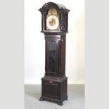 An early 20th century longcase clock, with a brass dial and three train movement,