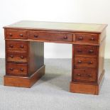 A Victorian mahogany pedestal desk, with a green inset writing surface, on a plinth base,