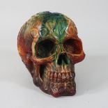 A modern carved coloured hardstone model of a skull,