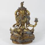 A gilt bronze figure of a deity, inlaid with coral and turquoise,