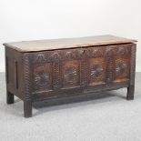 An 18th century carved oak coffer,