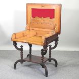 An unusual early 20th century light oak secretaire desk, with a hinged top and well fitted interior,