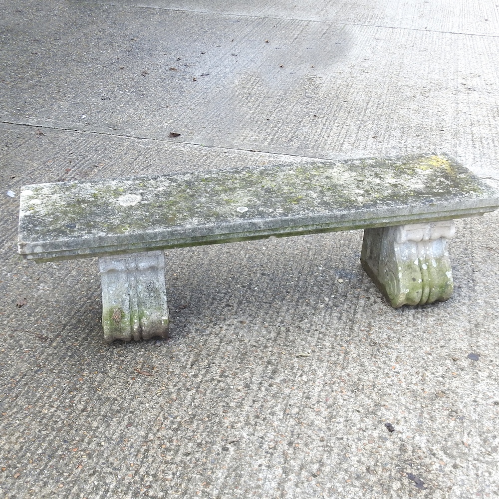 A reconstituted stone garden bench,